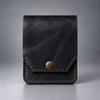Black compact leather snap pocket wallet front view with stitched flap