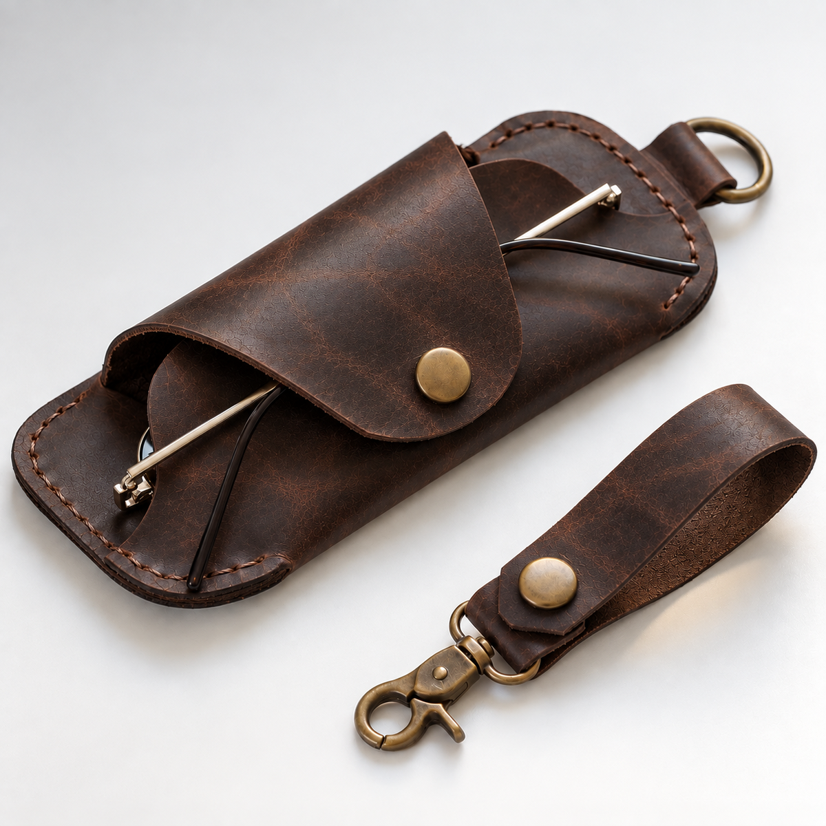 Dark brown leather eyeglasses holder with snap flap and matching keychain loop