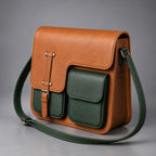 Side three-quarter view of tan and green leather multi-pocket messenger bag