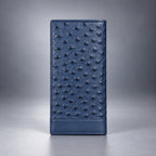 Blue ostrich leather travel wallet front view with raised quill texture