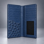 Open blue ostrich leather travel wallet showing card slots and ID window