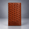Brown ostrich leather travel wallet front view with raised quill texture and stitched lower panel