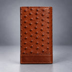 Brown ostrich leather travel wallet front view with raised quill texture and stitched lower panel