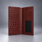 Burgundy ostrich leather travel wallet front view with raised quill texture