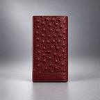 Open burgundy ostrich leather travel wallet with card slots and ID window