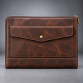 Dark brown zip-around leather laptop portfolio front view with envelope pocket